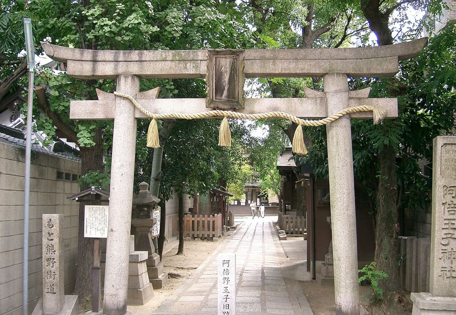 Stone torii with shimenawa rope and name pillar at Abeno Oji Shrine approach