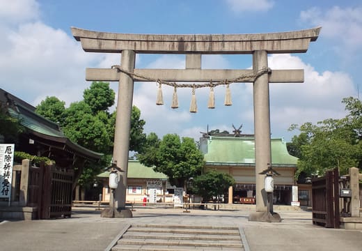 Large stone torii and steps at the entrance of Ikukunitama Shrine in Tennoji, Osaka