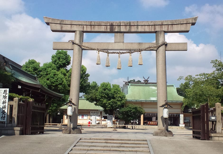 Large stone torii and steps at the entrance of Ikukunitama Shrine in Tennoji, Osaka