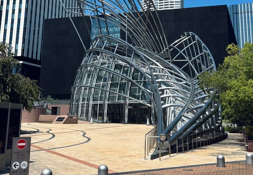 Steel-framed sculptural entrance of the National Museum of Art, Osaka against a clear blue sky