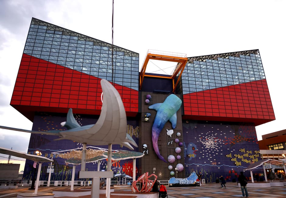 Osaka Aquarium Kaiyukan building with red and blue facade and whale shark sculpture